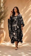 A  black and white floral print kaftan dress with tassel fringe, 