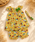 A baby girl's two-piece outfit set featuring a yellow sleeveless top with ruffled shoulders and matching shorts, both decorated with a colorful floral print. A matching yellow headband with green leaf accents is also included.